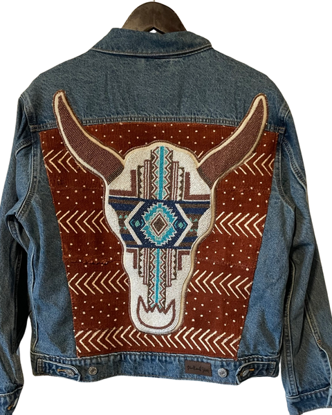 Denim jacket with added hand beaded blue Southwest cow skull on African Mud cloth