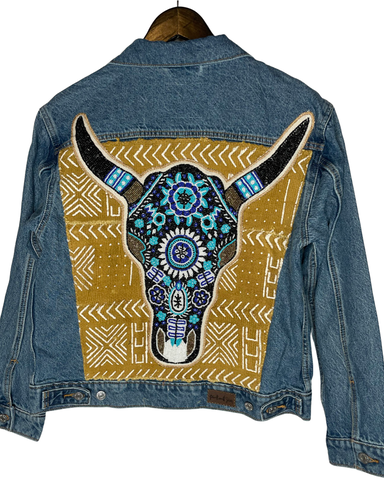 Denim jacket with added hand beaded blue cow skull on African Mud cloth